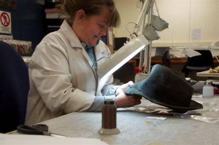 Sarah repairing ice axe holes to a hat Photo 1.jpg