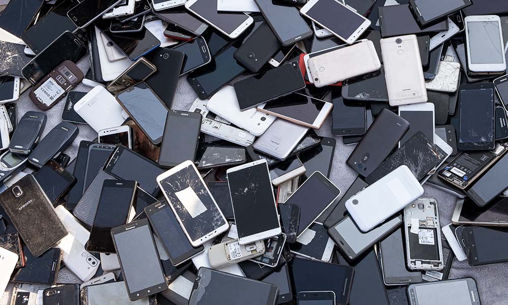 A pile of broken smartphones