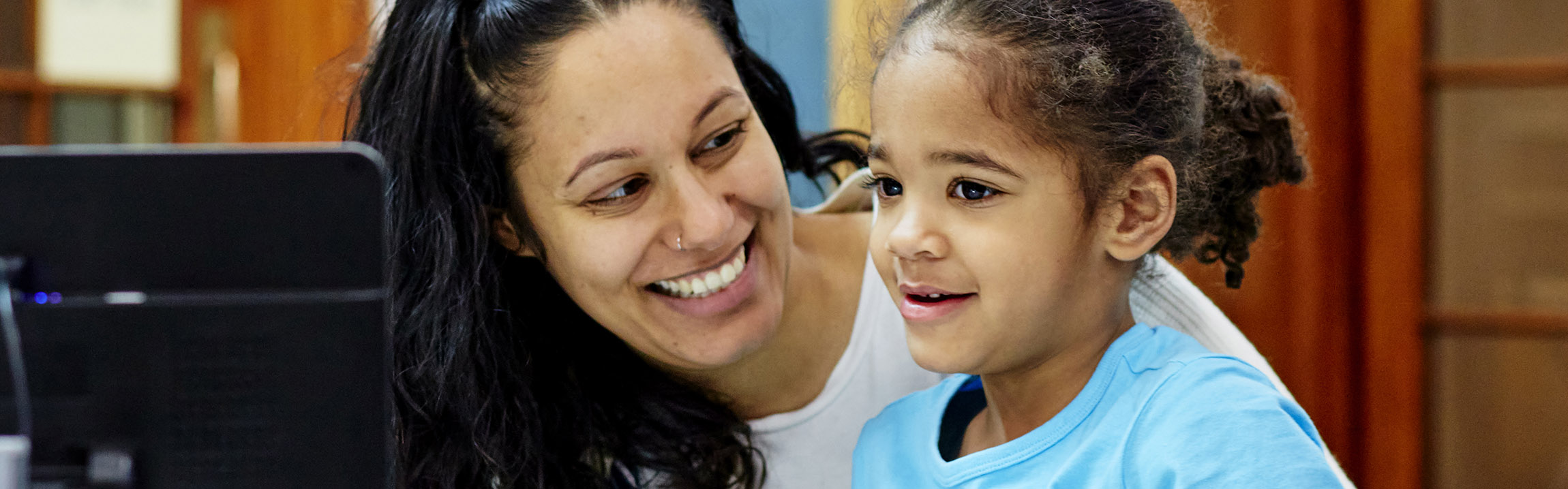 A woman and a girl smiling