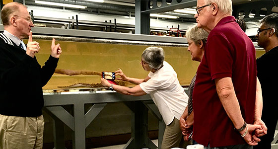 John Wilson signs in BSL to people visiting the Spirit Collection and taking pictures of the squid