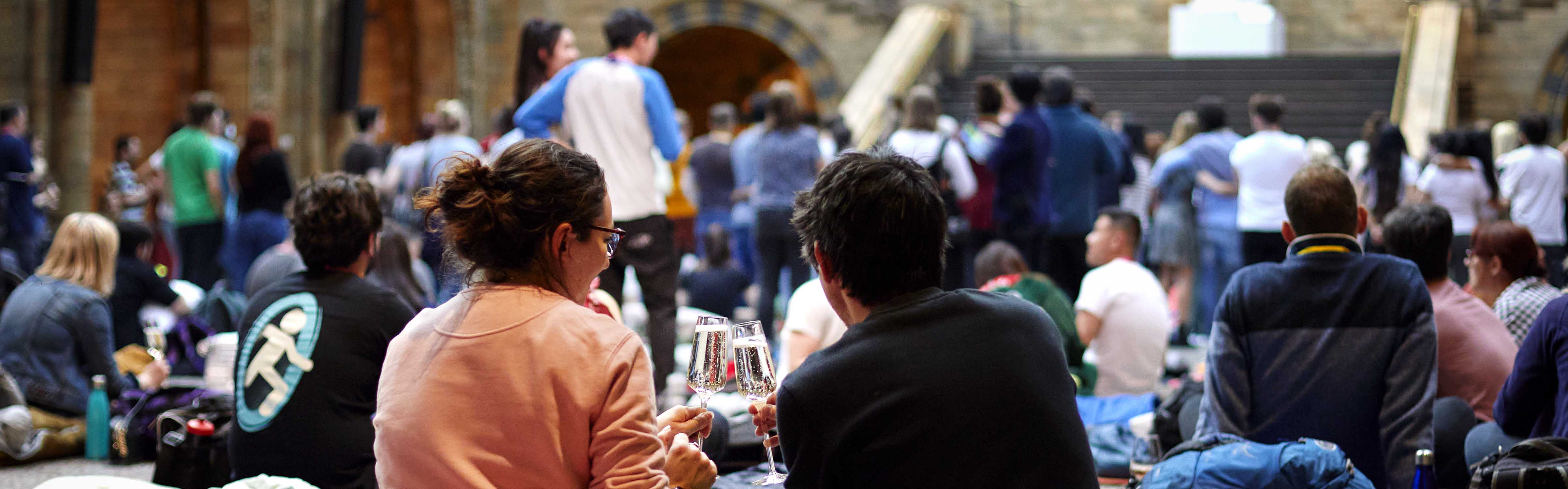 People sit on the floor of Hintze Hall during a sleepover