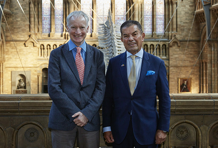 Two men in suits stand side by side in the museum
