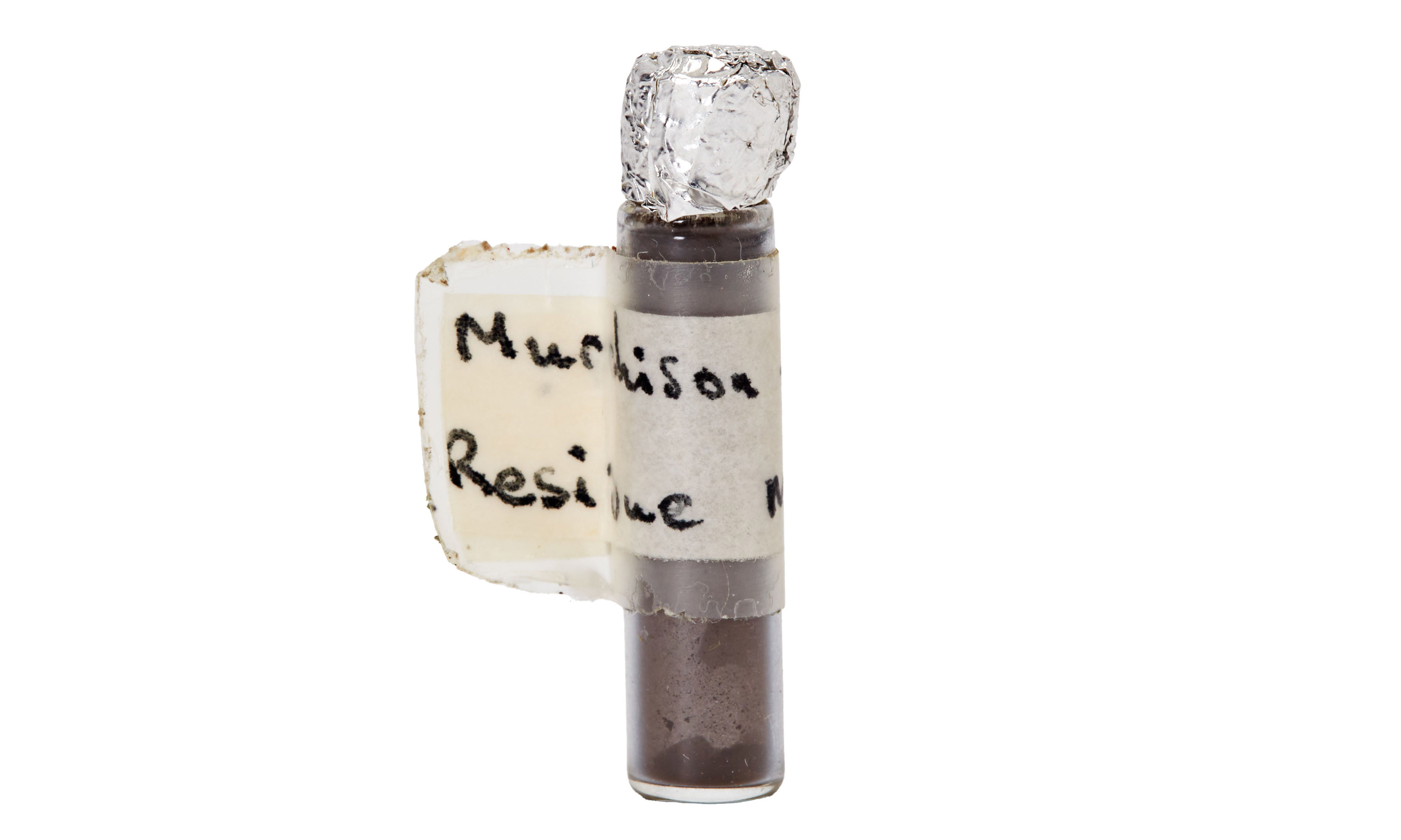 A small tube with brown dust over a white background
