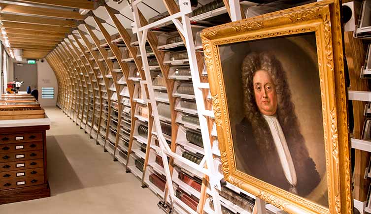Sloane’s herbarium, showing the horizontally stored volumes and a portrait of Sir Hans Sloane