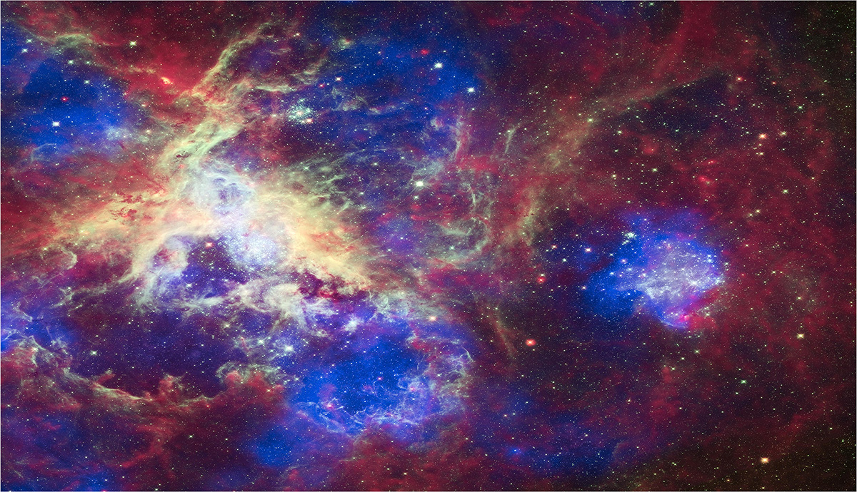 Bubbles of superheated gas (blue) break up cooler gas and dust (red). The sky is also filled with hundreds of stars. 