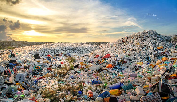 An enormous pile of plastic rubbish forms a mound in the foreground, as more plastic streches out into the distance.  
