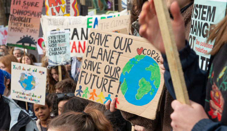 Activists holdplacards at a Youth Strike 4 Climate demonstration rally in Parliament Square