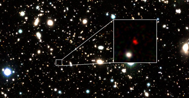 Ancient galaxy shines through the clouds of the early