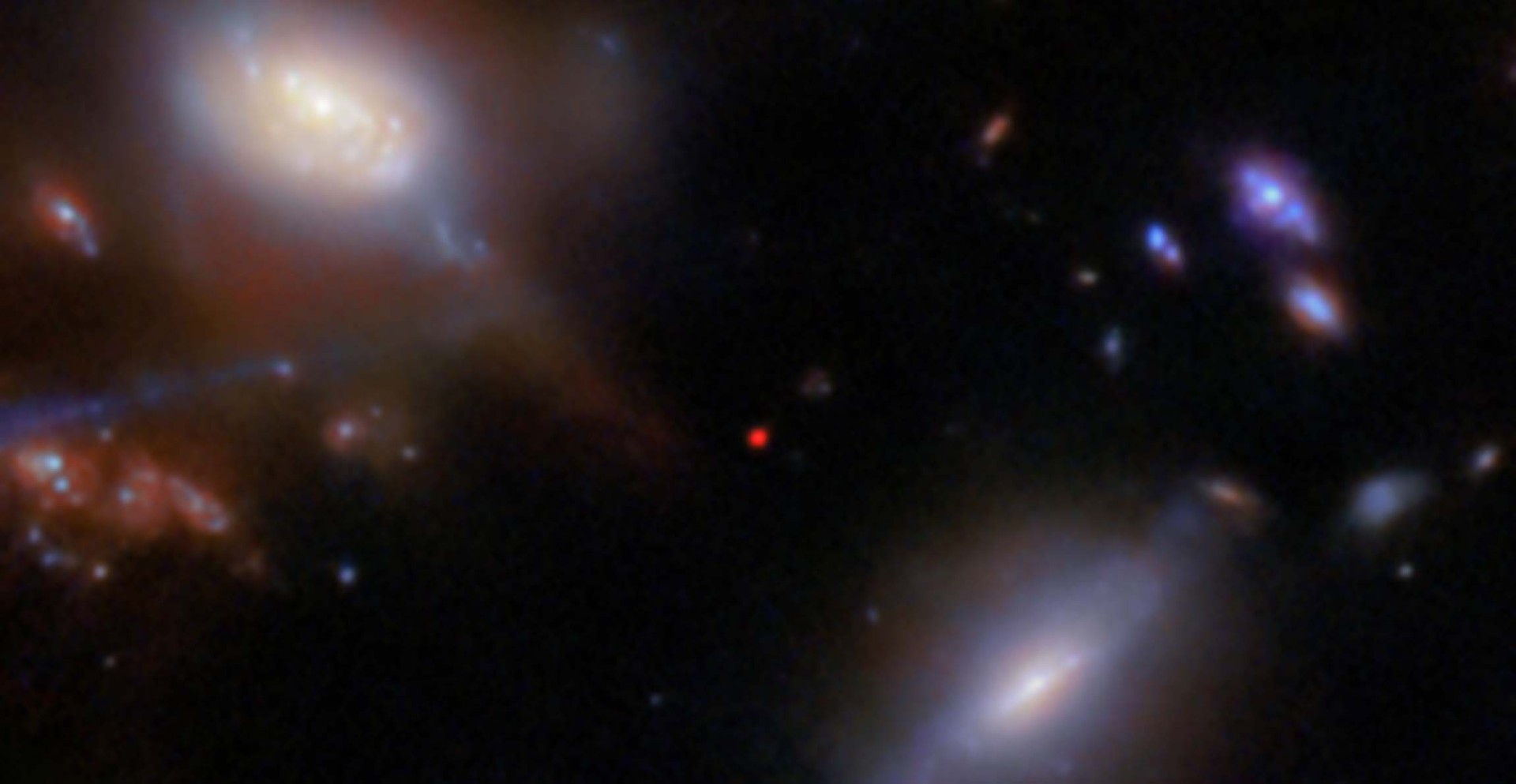 Ancient galaxy shines through the clouds of the early