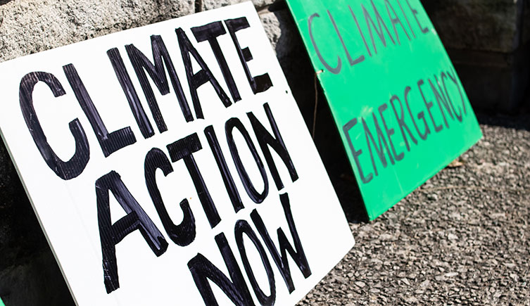Placards that read 'Climate Action now' and 'Climate Emergency'