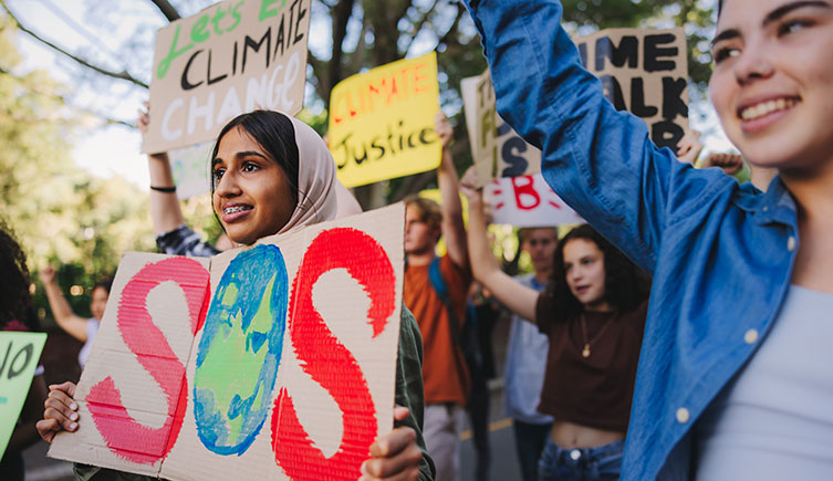 Young activists holding up signs at a climate change strike