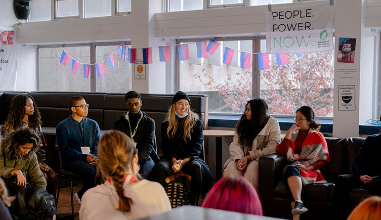 A group of young climate activists in discussion at a community event