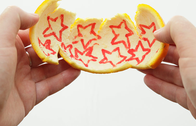 Several stars have been drawn in red on the inside of orange peel
