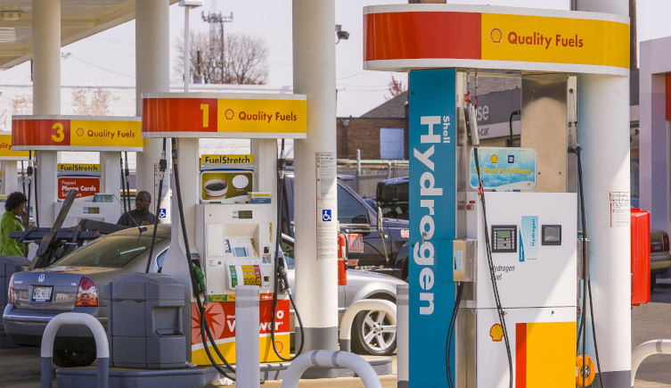 A petrol station with fossil fuel and hydrogen pumps