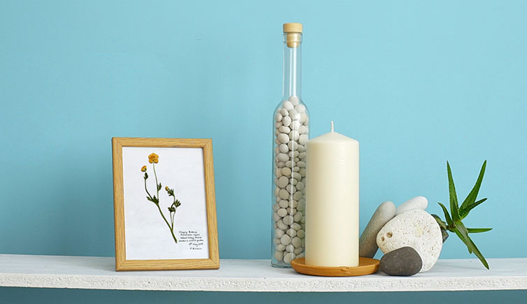 A shelf featuring pressed flower art