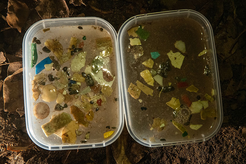 Two tubs filled with water an plastic fragments