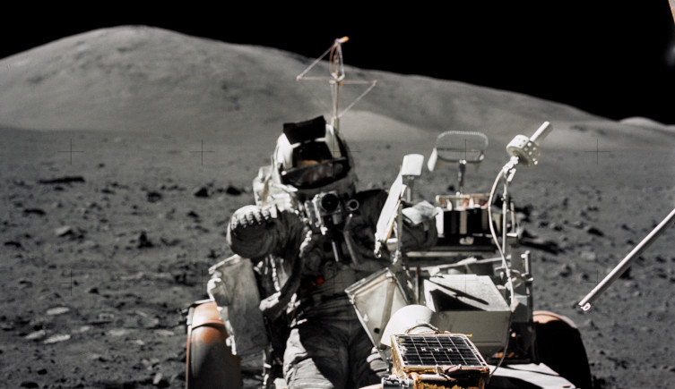 Astronaut Harrison Schmitt seated in a lunar rover on the Moon during Apollo 17