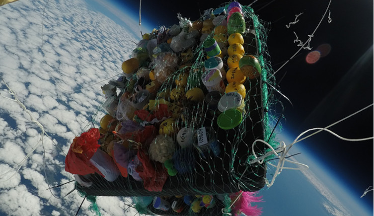 The experiment falls back to Earth in the upper atmosphere after the balloon bursts. 