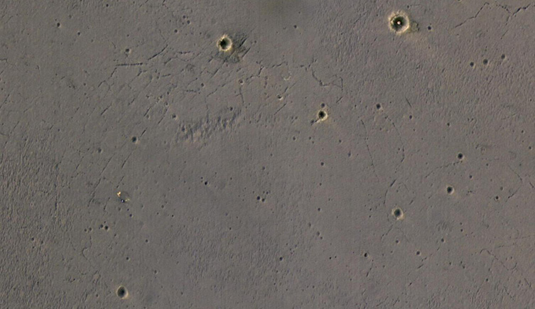 A picture of the surface of Mars showing it pocked with impact craters. 