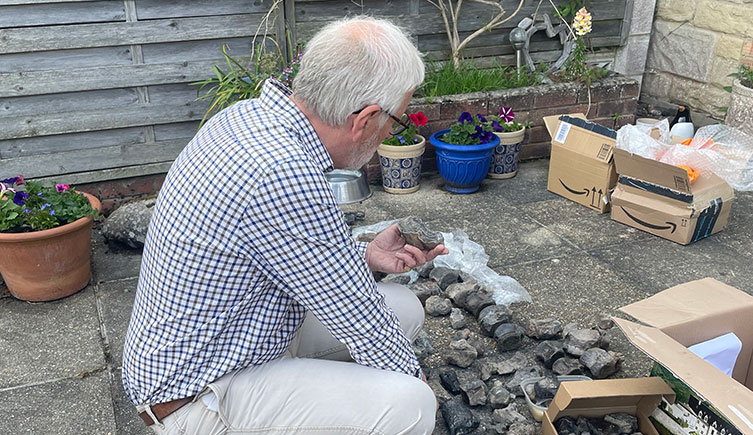 Jeremy Lockwood looking at dinosaur fossil bones