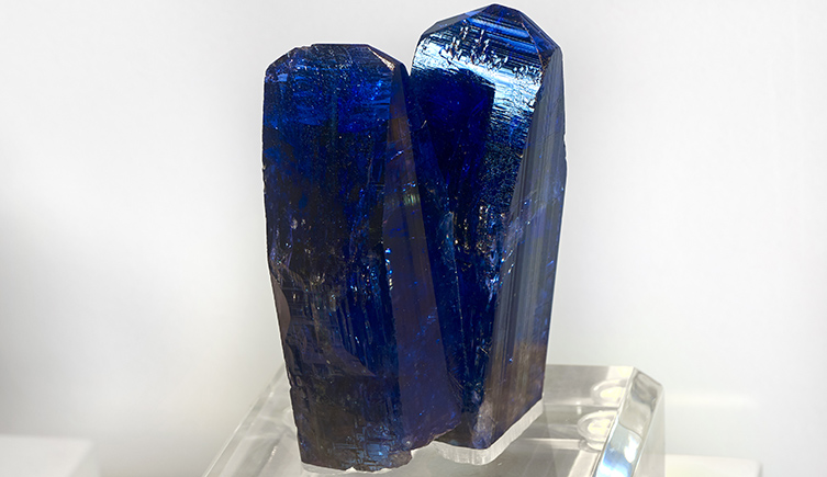 Two tall crystals both a deep metallic, violet-blue in in colour.