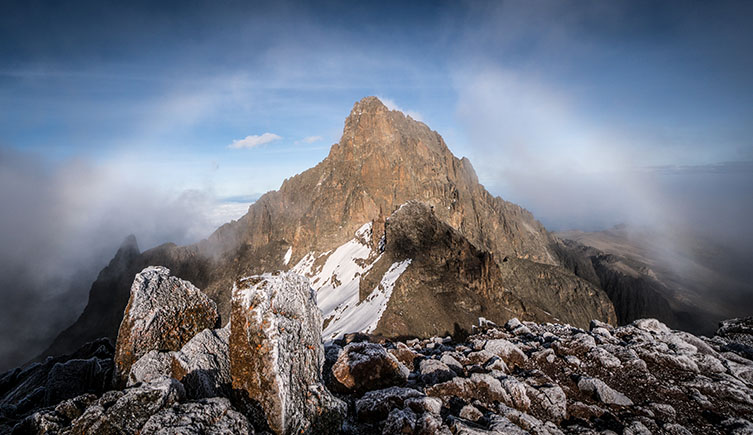 A view of the snow covered, rocky peak of Mount Kenya. 