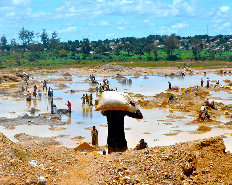 Local people wash copper ores in a mining site