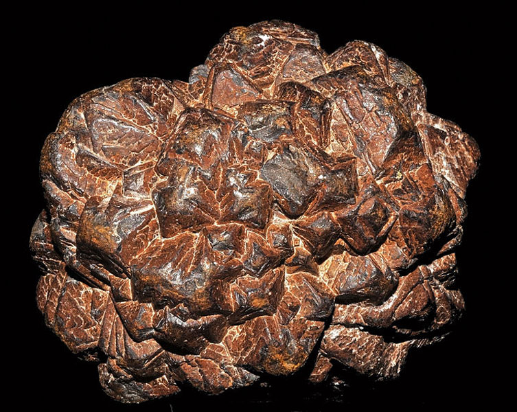 A brown coloured rock with many grooves