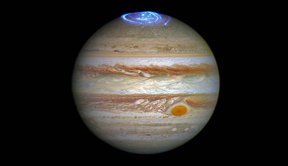 A blue aurora dances over Jupiter’s northern pole.