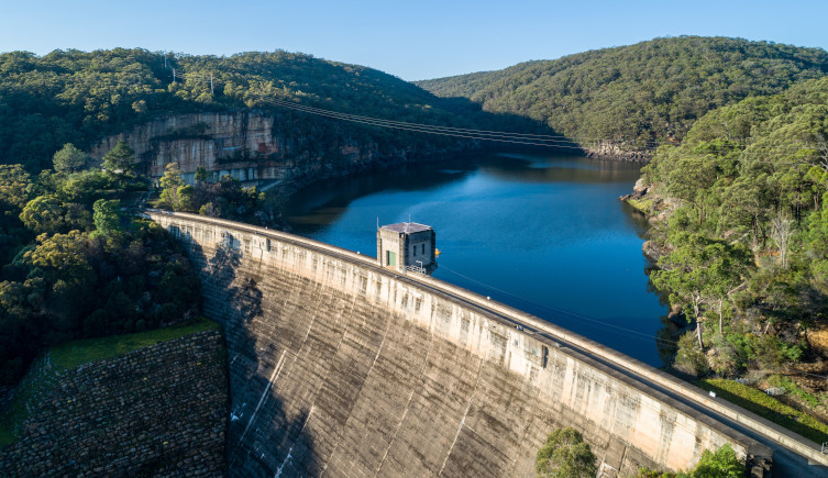 The arched wall of the Nepean Dam holds back the reservoir behind