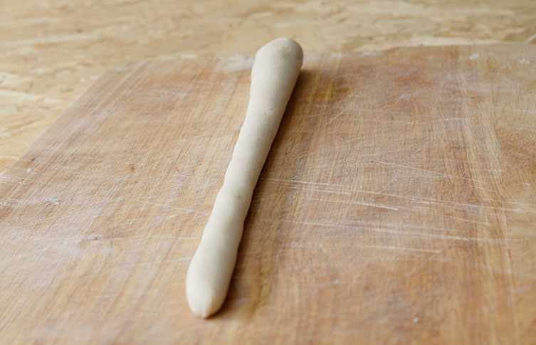 Salt dough rolled out into a tapered sausage-shape