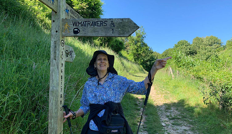Sandy walks along a countryside path with a big smile