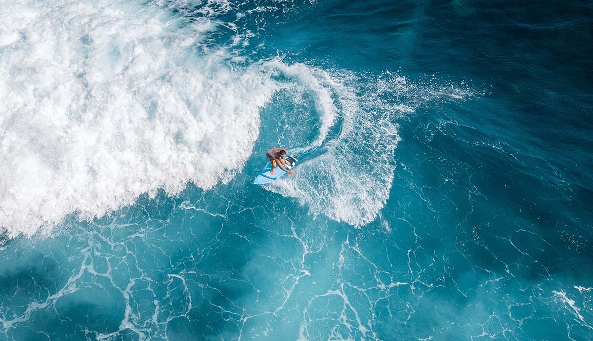 A surfer rides a wave on the ocean.
