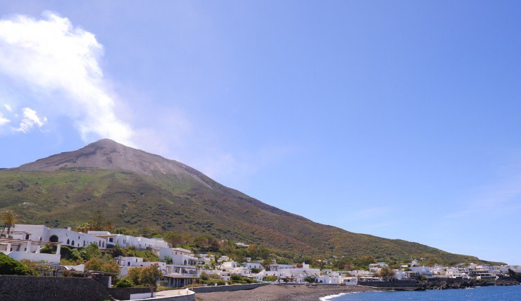 Stromboli towers over a small village in the foreground