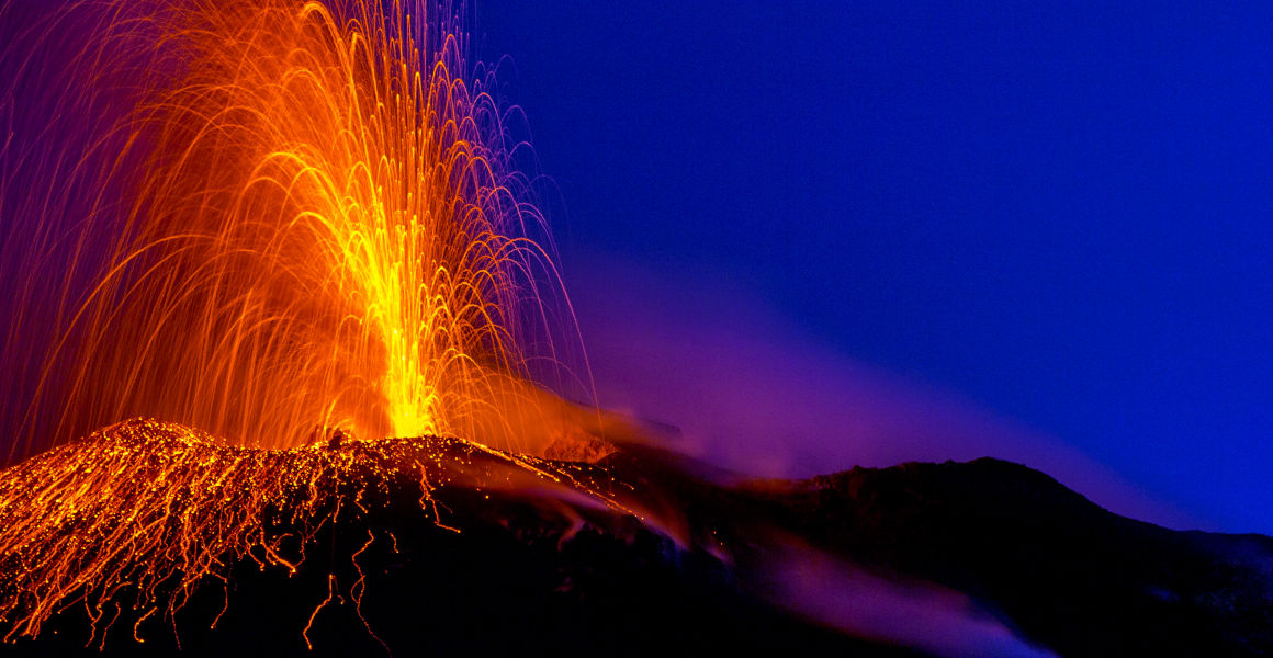 A lave fountain erupts from Stromboli at night