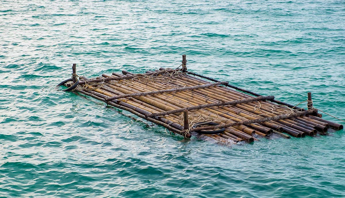 A wooden raft floating in the ocean.