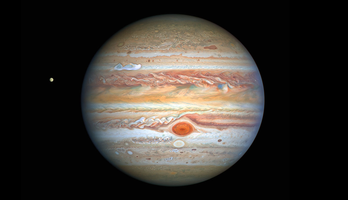 A large red, orange and white striped planet