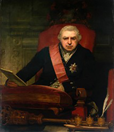 A portrait of Banks sitting in a red chair wearing a uniform
