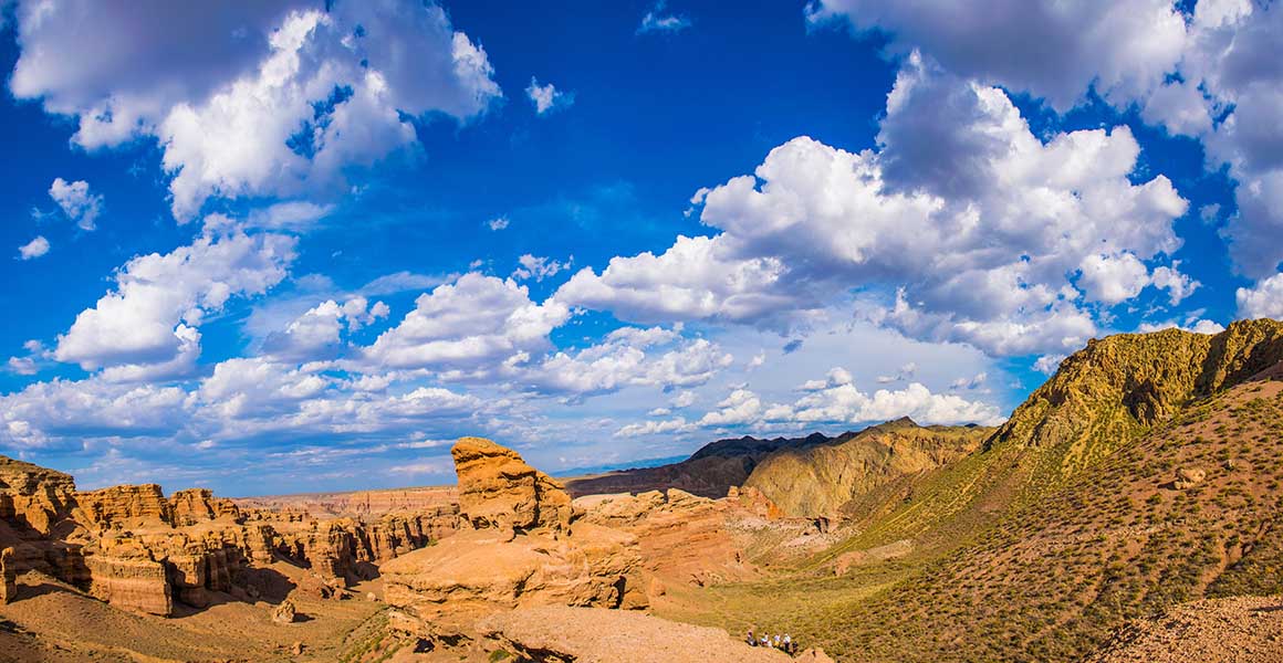 A view of arid mountains covered in light scrub.