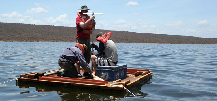 A scientific team collecting lake sediment samples. 