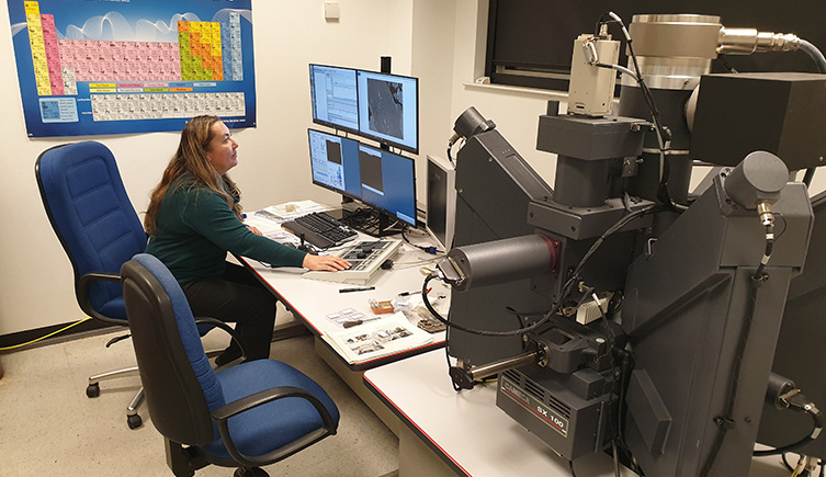 A researcher looking at a screen in a lab 