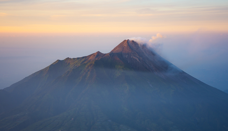 Photograph of a volcano with steam coming out of the top