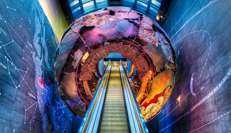 The Museum's Earth Hall, showing the escalator that ascends through a giant Earth-like sphere