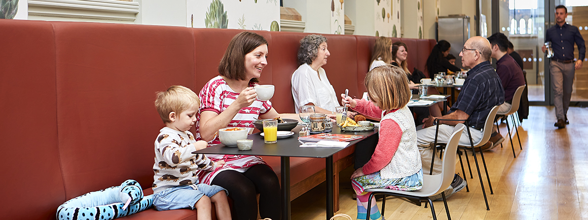 A photograph of a family enoying the Anning Rooms for members