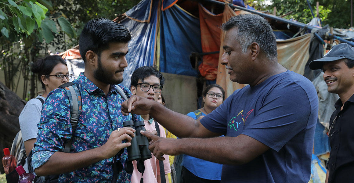 Wildlife Photographer of the Year photographer Dhritiman Mukherjee teaches photography skills to a group of young people.