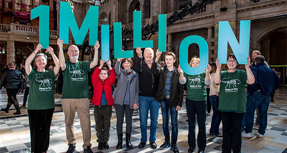 People holding up letters that spell '1 million'