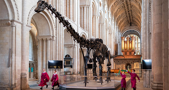 Dippy in Norwich Cathedral, with choristers jumping beside it