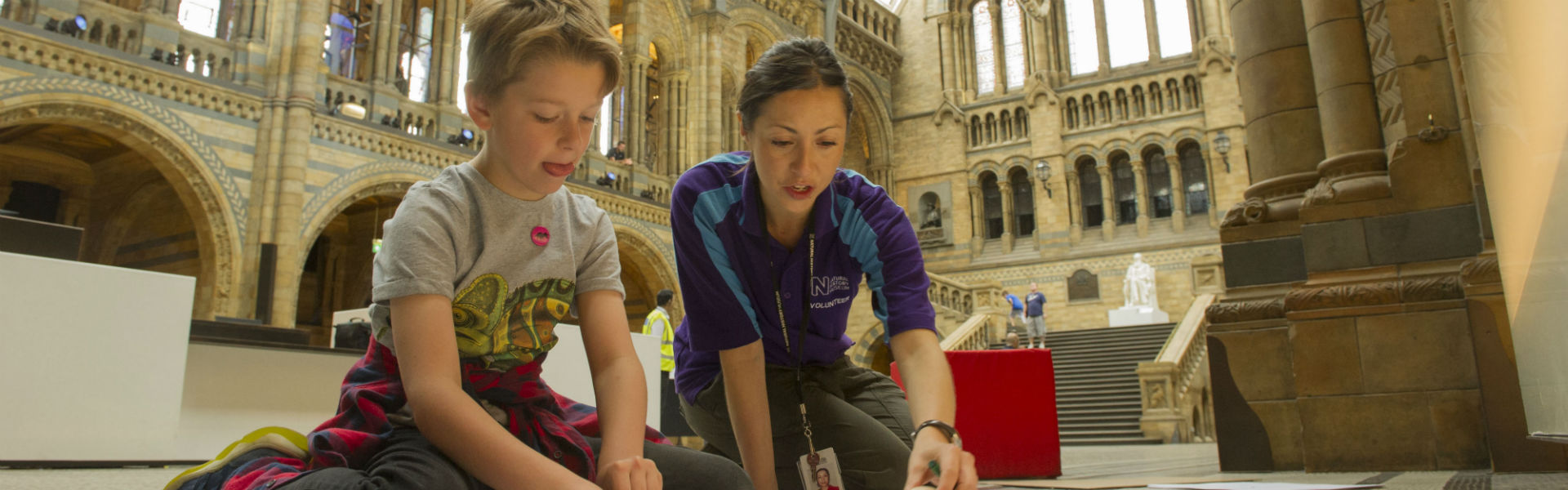 A photograph of a child doing an activity in Hintze Hall