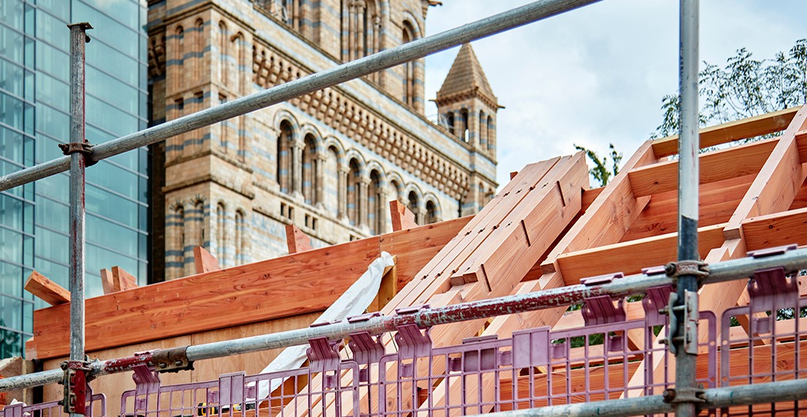 A roof underconstruction of the Kitchen Garden, with the museum in the background