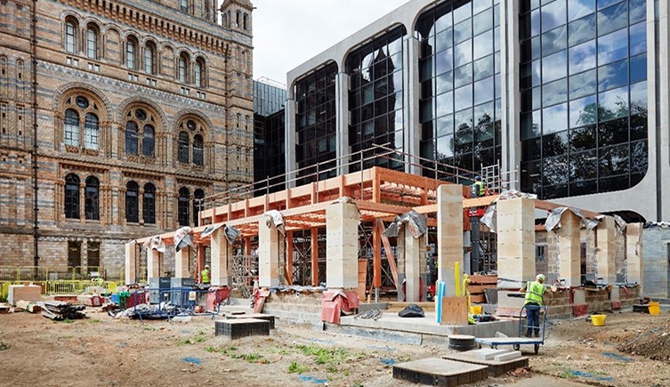 The natural history museum's waterhouse building in the background and a building being constructed in the foreground